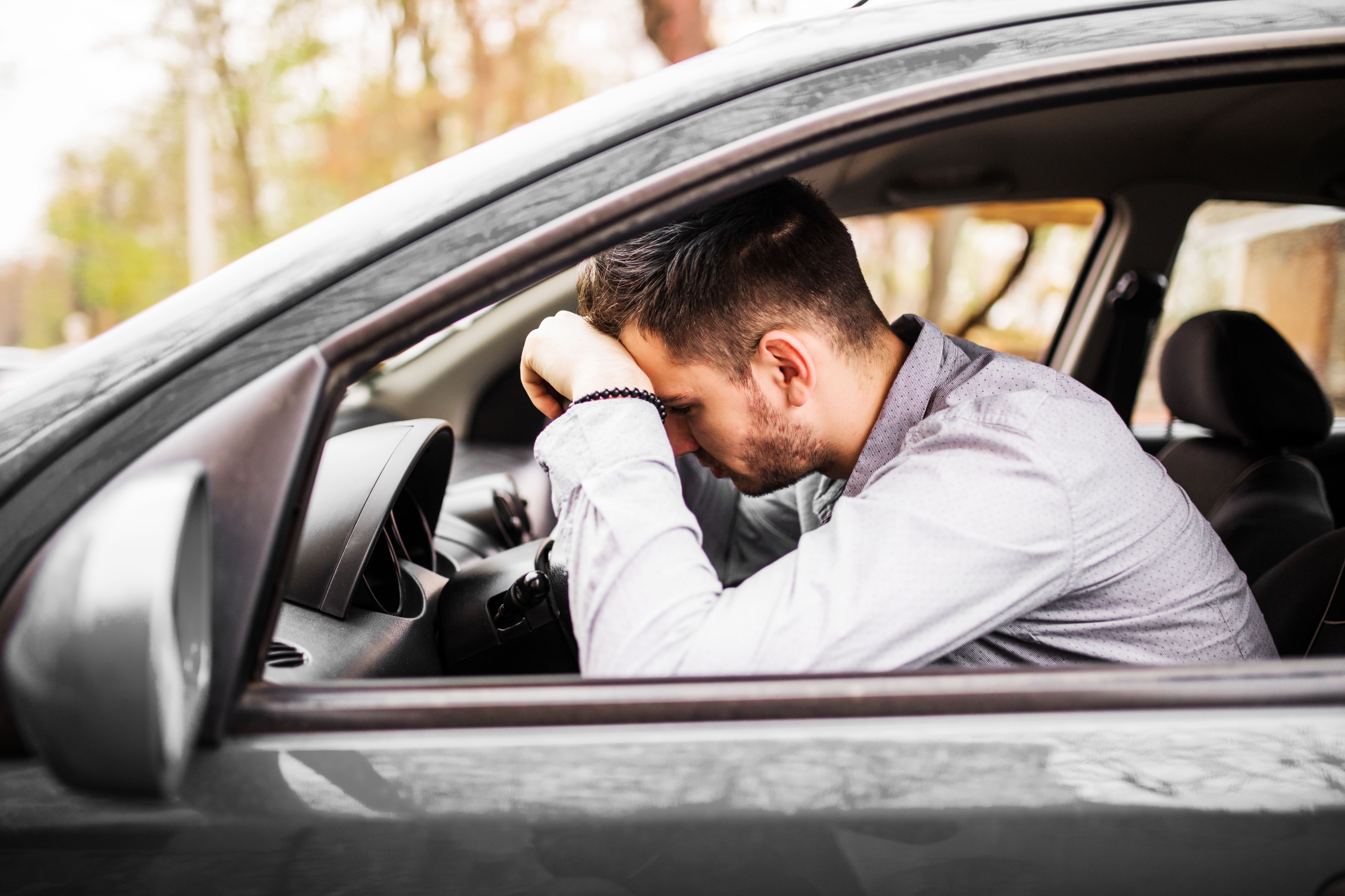 young-man-sitting-car-very-upset-stressed-after-hard-failure-moving-traffic-jam (1).jpg